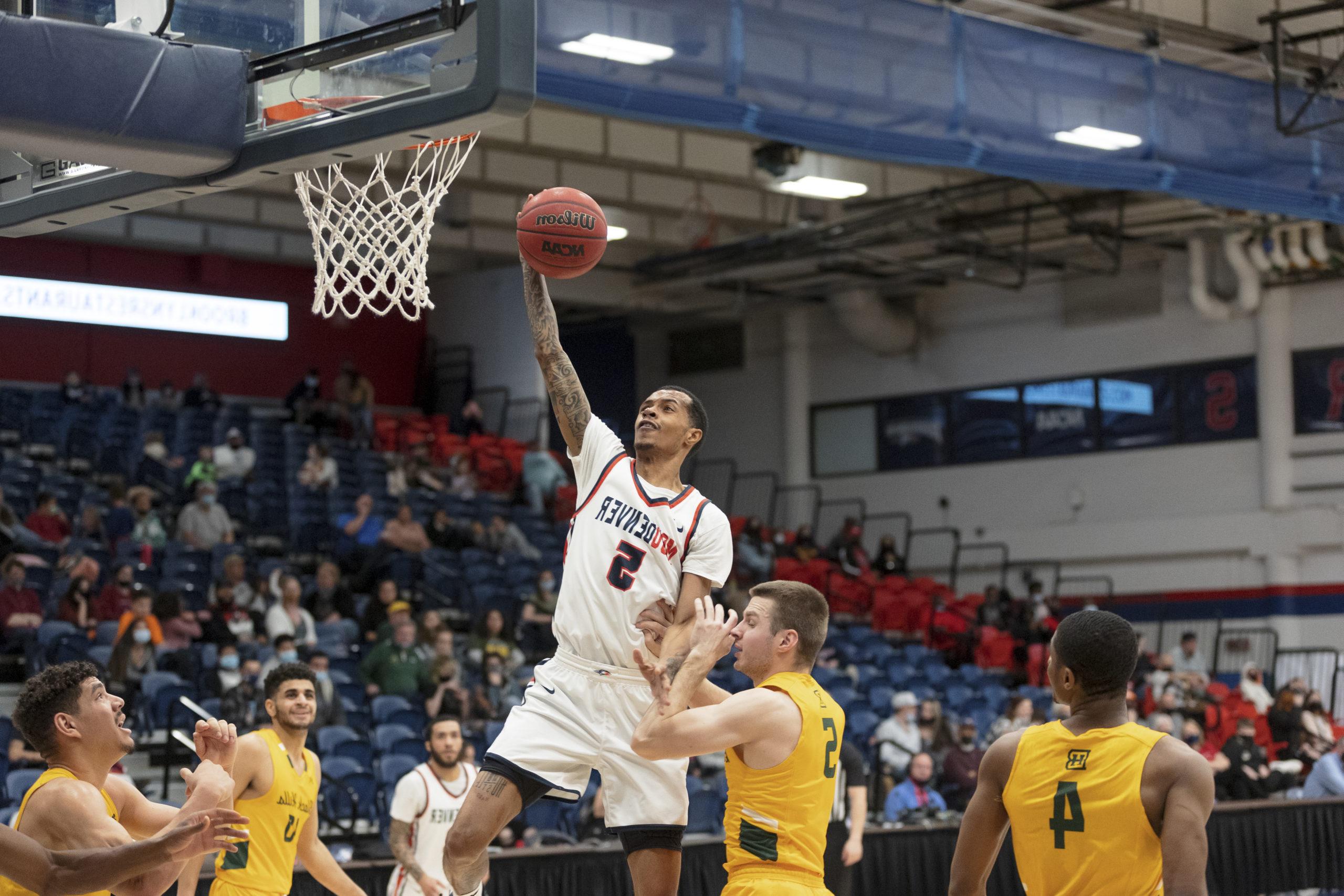 Men's basketball player Tyrei Randall skies for a left-handed layup vs. Black Hills State in 2022.